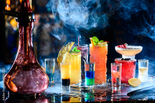 Set of alcoholic cocktails in a hookah with beautiful smoke and space for text.