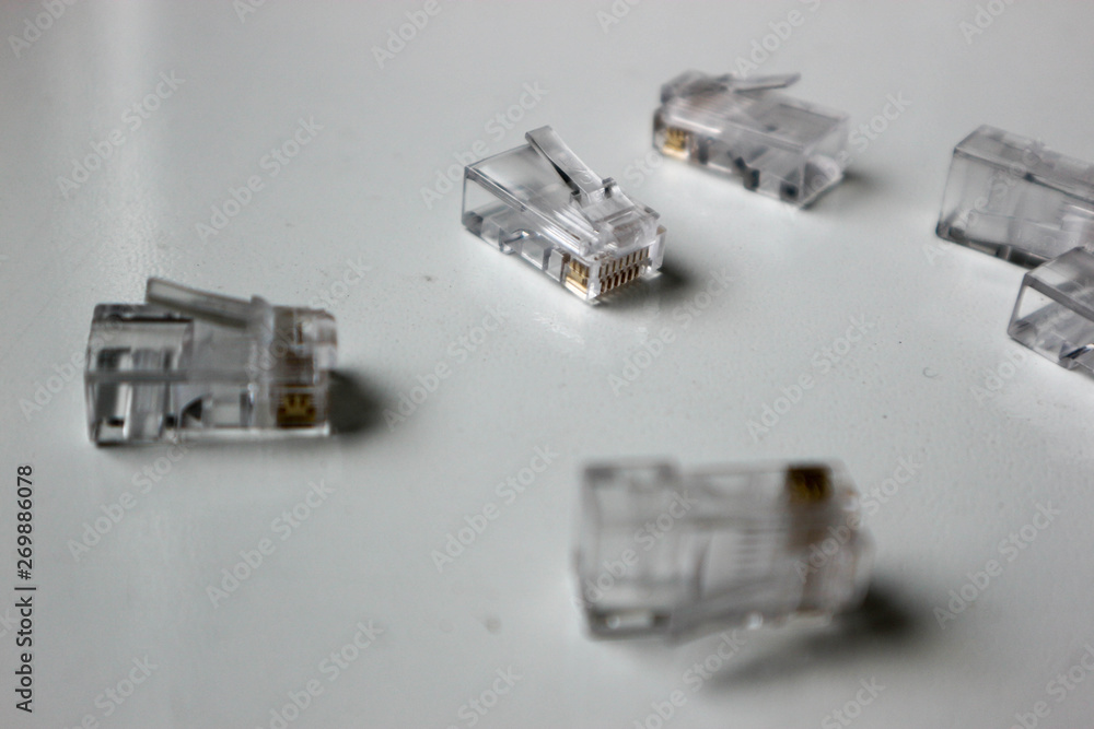 couple of rj-45 8P8C internet connectors on a white table couple of rj-45 8P8C internet connectors on a white table