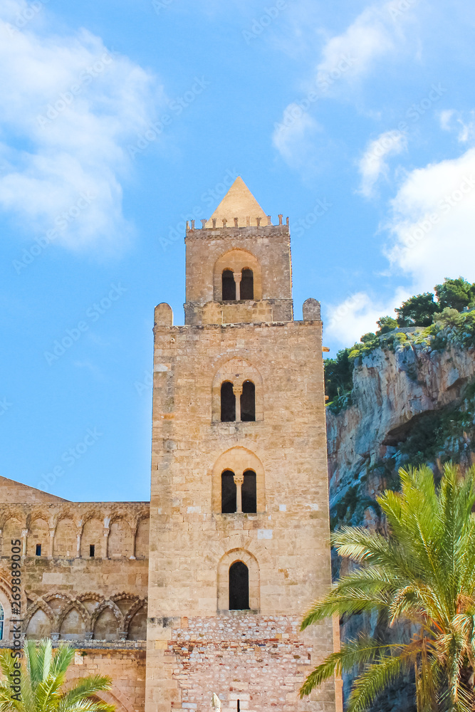 Detail of beautiful Cefalu Cathedral in Cefalu, Sicily, Italy with blue sky. Roman Catholic basilica in Norman architectural style, part of UNESCO World Heritage Site