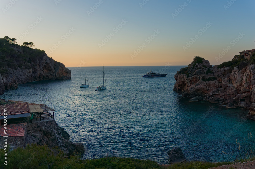 Beautiful beach on the island Majorca, Spain, in deia porto deia stone beach with yacht