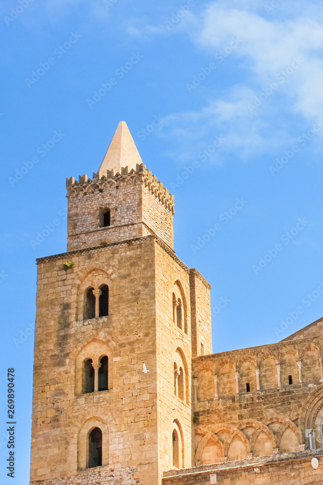 Vertical picture capturing detail of one of the towers belonging to Cefalu Cathedral in Sicily, Italy. Roman Catholic basilica in Norman architectural style is popular tourist spot. UNESCO Heritage