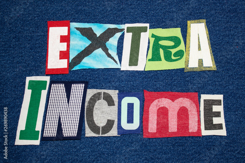 Foto EXTRA INCOME text word colorful fabric collage on blue denim, side hustle, horiz