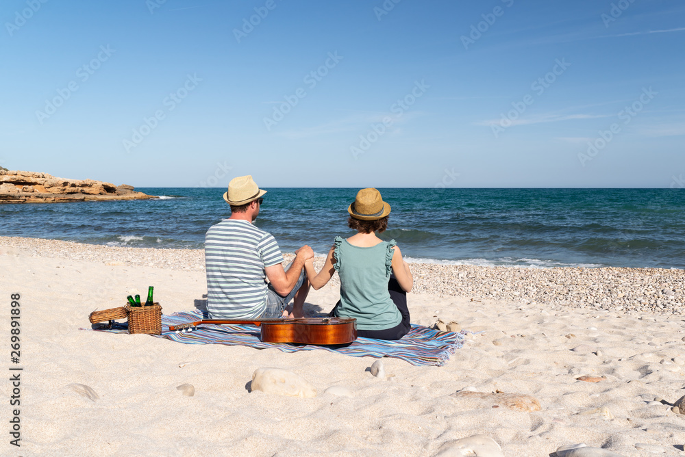 Romantic couple having a picnic at a mediterranean beach