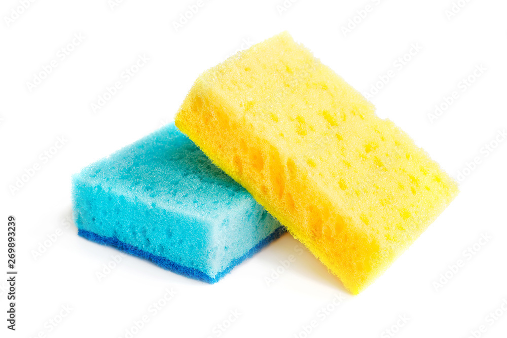 Colored sponges for washing dishes and other domestic needs. Yellow sponge lies on blue sponge at a slight angle. Isolate - obrazy, fototapety, plakaty 