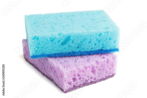 Colored sponges for washing dishes and other domestic needs. Blue sponge lies on a violet sponge at a slight angle. Isolate