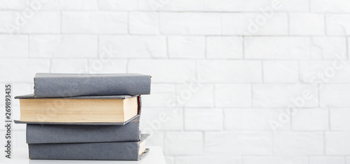 Tableau sur toile Stack of books on table at white background