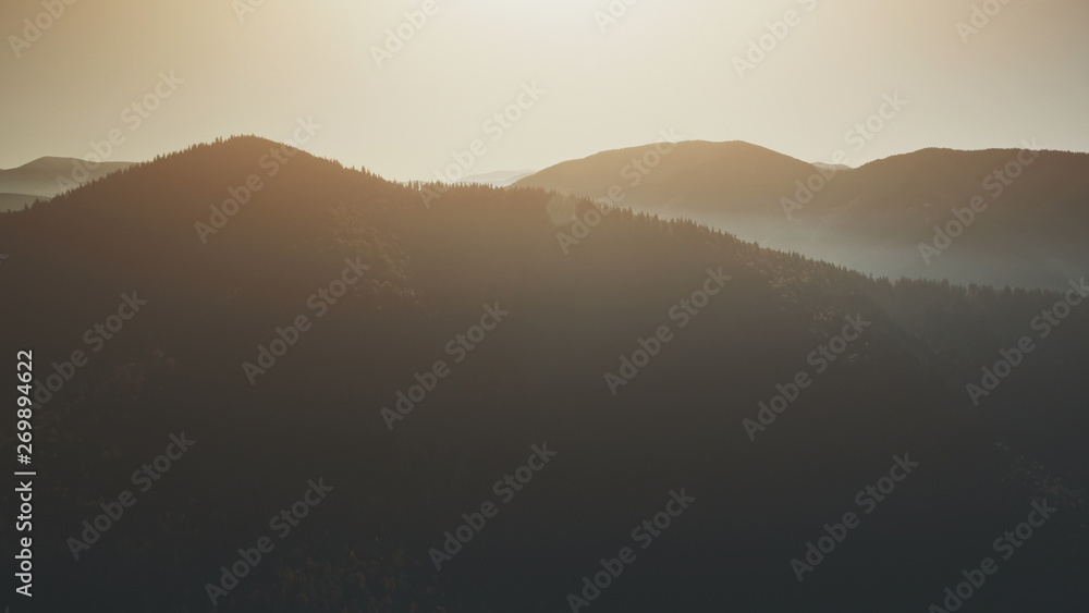 High Mountain Peak Slope Sunrise Sight Aerial View. Highland Wildlife Natural Habitat Foggy Scenery Overview. Rocky Evergreen Forest Eco Friendly Environment Concept Drone Flight