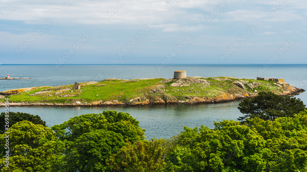 The uninhabited Dalkey Island, with visible ruins of a church, a gun battery and a Martello Tower, as seen from Dillon's Park in Dublin Ireland. Important site of ancient and historic remains.