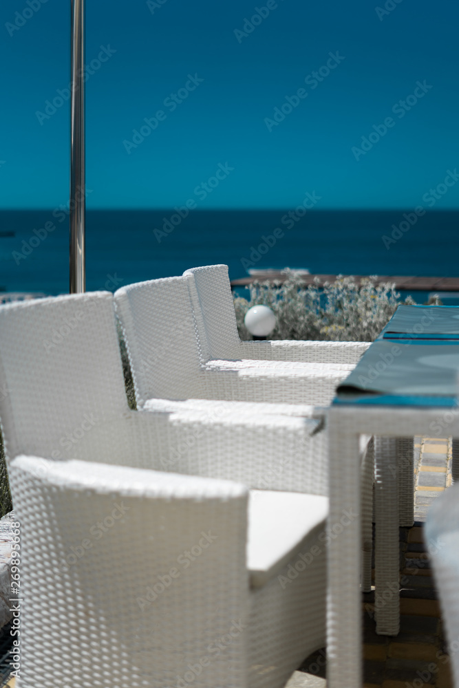 Fototapeta premium White chairs on the sea