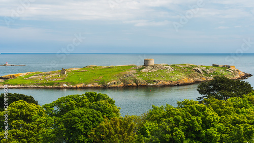 Photography The uninhabited Dalkey Island, with visible ruins of a church, a gun battery and a Martello Tower, as seen from Dillon's Park in Dublin Ireland