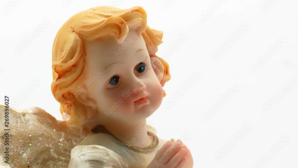 Beautiful little angel statuette on a white background 4k Beautiful little angel statuette on a white background 4k