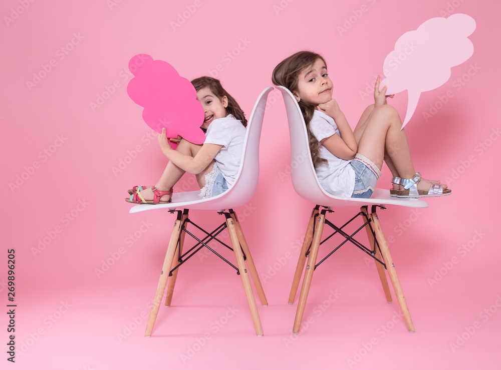 two girls on a colored background with speech icons two girls on a colored background with speech icons