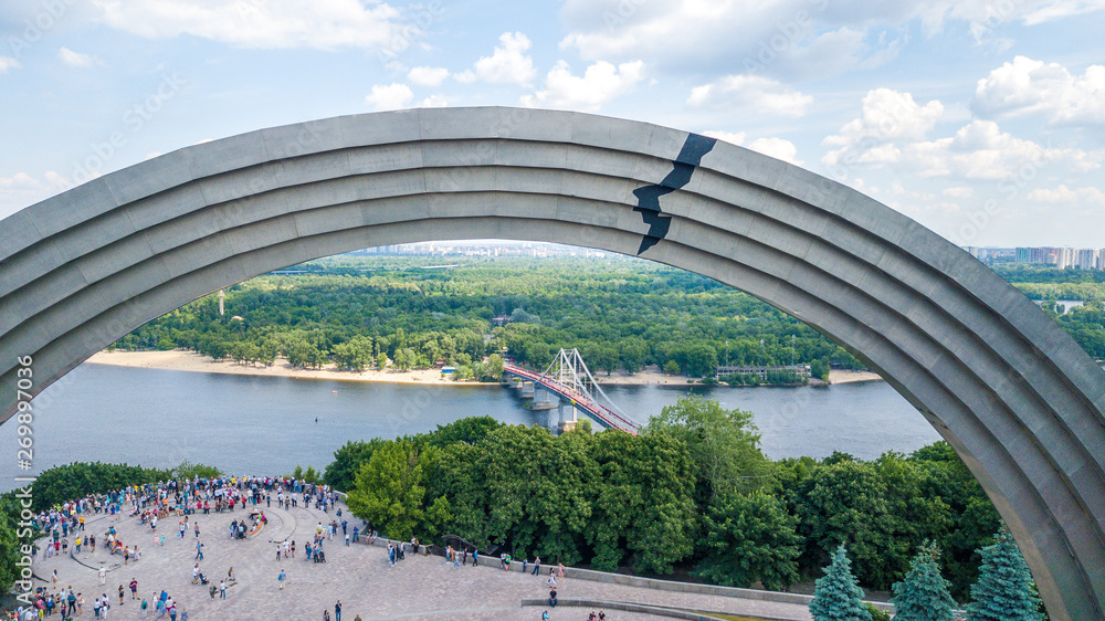 Fototapeta premium Panoramic view of Kyiv. Arch of Peoples Friendship, pedestrian bridge. View of Kyiv with a dron