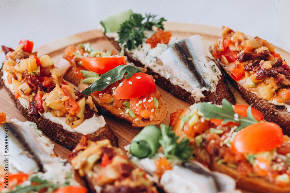 sandwich with trout, cherry tomatoes and lettuce. a plate of snacks. sandwich with trout, cherry tomatoes and lettuce. a plate of snacks.