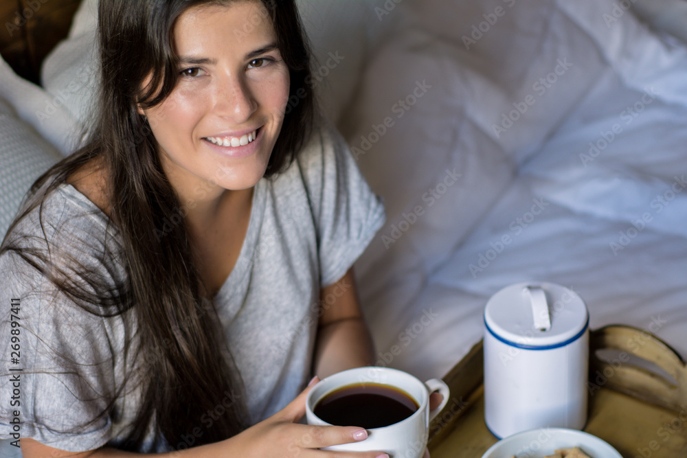 Young woman having breakfast in bed Young woman having breakfast in bed