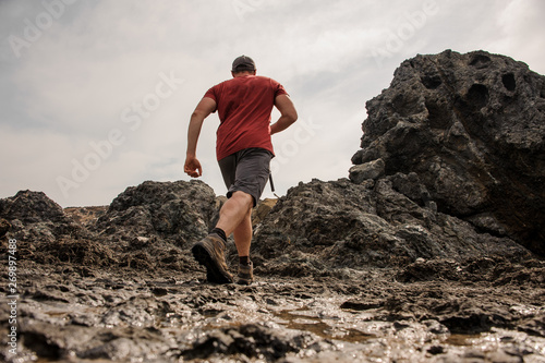 Man running on the rocks in the mountains