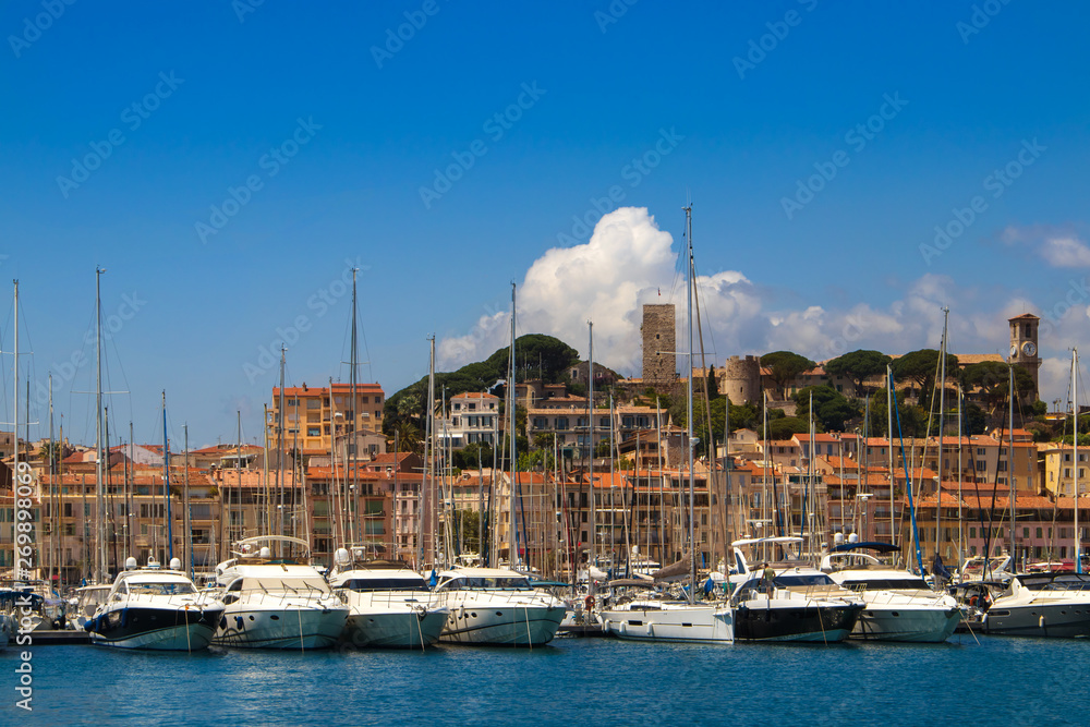 Old city and harbor in Cannes, French Riviera, France. Many yachts on the pier. Old city and harbor in Cannes, French Riviera, France. Many yachts on the pier.