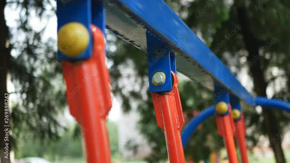 baby swing, after the rain in the park. Empty swing seats rocking on the playground in the park. baby swing, after the rain in the park. Empty swing seats rocking on the playground in the park.