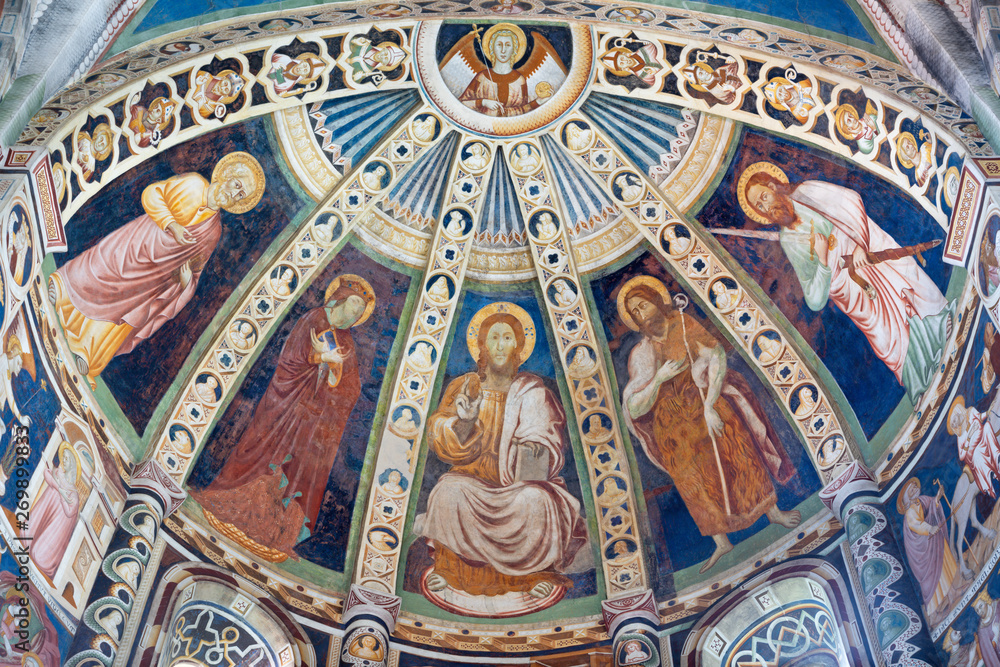 COMO, ITALY - MAY 9, 2015: The fresco with the Jesus and saints (Peter, Mary, Baptist, Paul) in apse of church Basilica di San Abbondio by unknown artist 