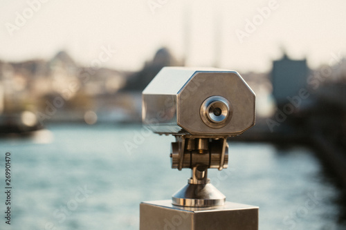 Coin binoculars viewer near the waterfront overlooking the bay and the city.