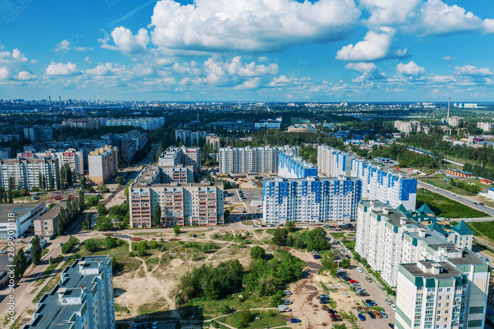 Typical outskirts of Russian city with high-rise buildings in sunny day, aerial view