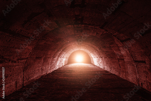 Underground tunnel or corridor with red light in end, thriller or horror atmosphere concept