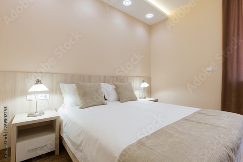 Hotel room interior, beige bedroom © rilueda