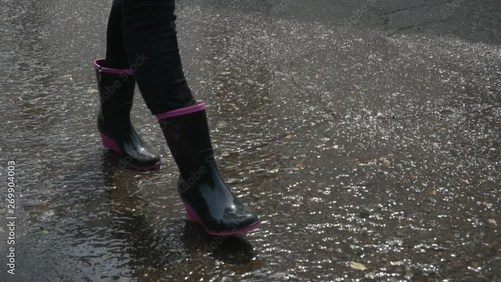 walking through the puddles in rubber boots walking through the puddles in rubber boots