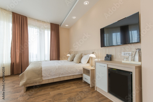 Hotel room interior double bed beige bedroom