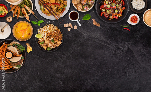 Asian food background with various ingredients on rustic stone background , top view. Vietnam and Thai cuisine.