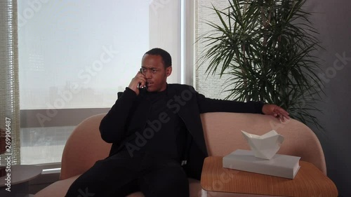 Angry African American Man talking on cell phone. photo