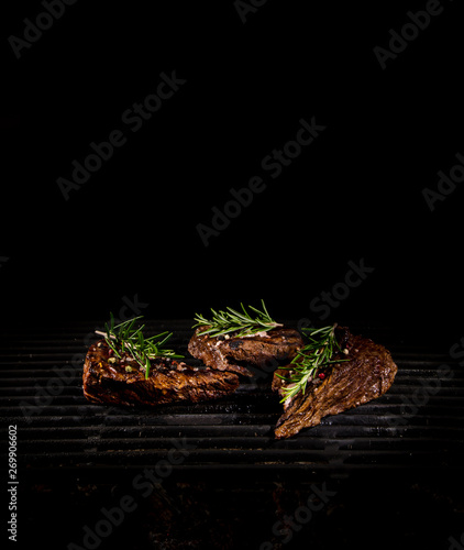 Tasty Beef steaks on iron c...