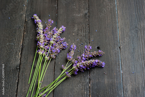 Fototapeta Naklejka Na Ścianę i Meble -  purple lavender flowers on black wooden table background