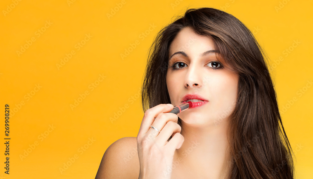 Woman applying lipstick Woman applying lipstick