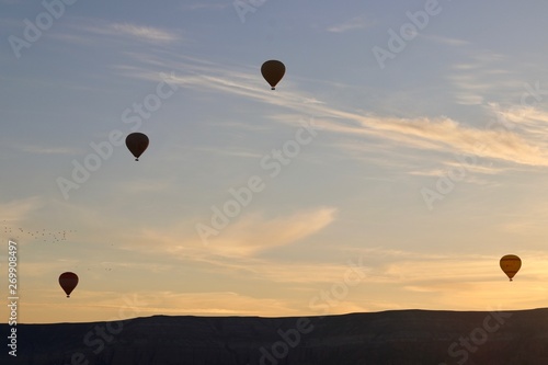 Hot air balloons in the air during sunrise.