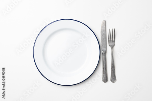 Empty plate and cutlery on white background, top view. Table setting