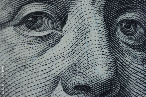 Enigmatic Macro Gaze: The Eyes of Benjamin Franklin on the $100 Bill. Benjamin Franklin's All-Seeing Eyes: A Captivating Macro View.