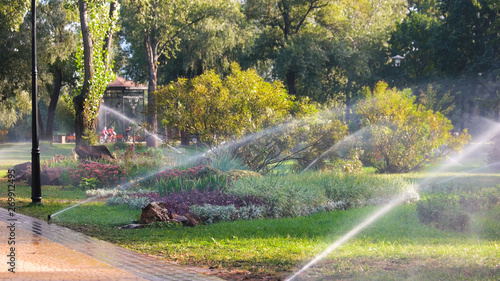 Canvas-taulu Pouring grass and flowers by irrigation water system