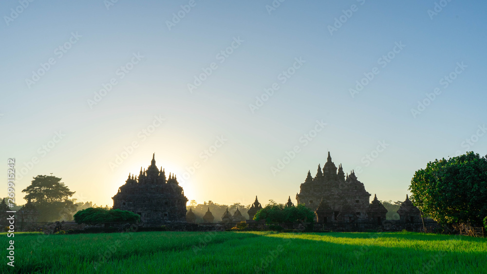 the view of the sunrise in a village with a plaosan buddhist temple background in Yogyakarta, Indonesia the view of the sunrise in a village with a plaosan buddhist temple background in Yogyakarta, Indonesia