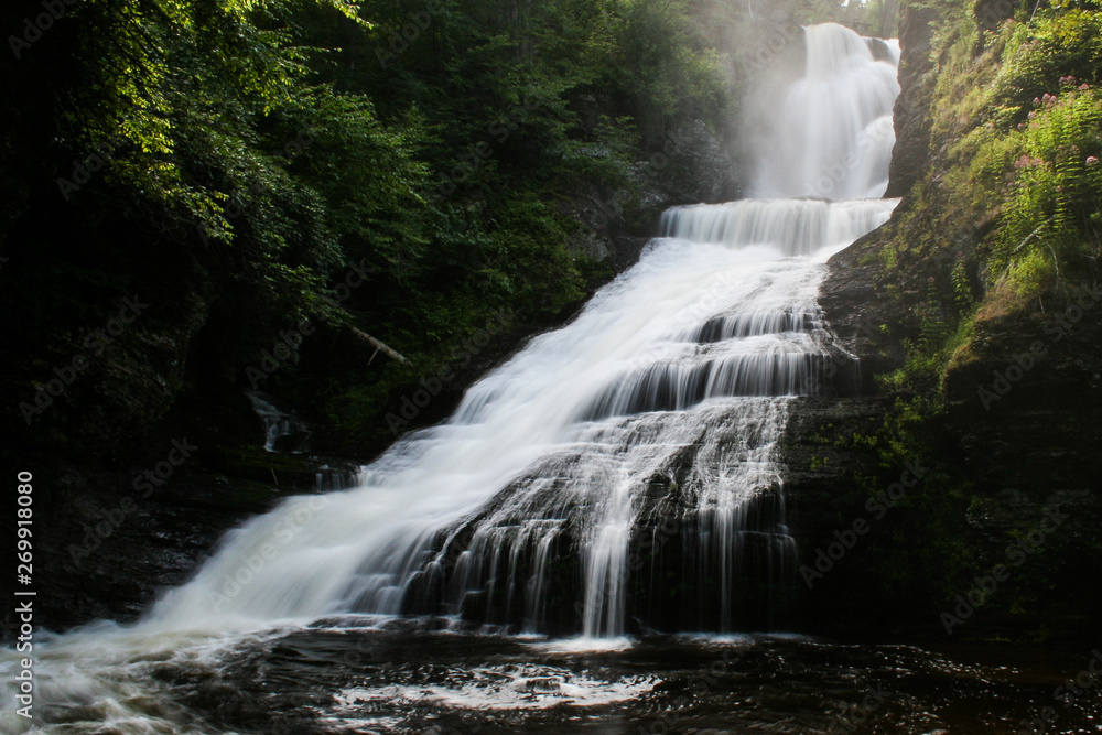 Fototapeta premium A waterfall in a forest. Dingman's Falls, Delaware Water Gap National Recreation Area, PA, USA.