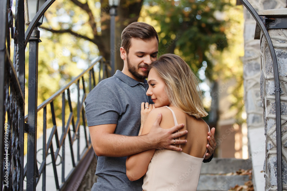 Young man and woman, couple in love embracing in the city Young man and woman, couple in love embracing in the city