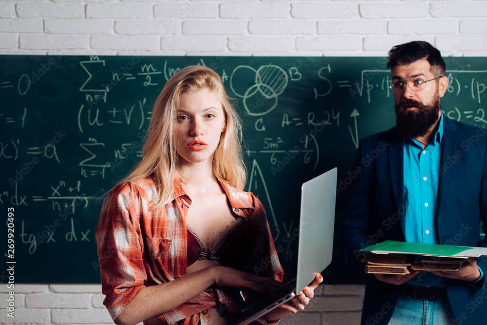 Couple of pretty sexy girl student holding heap of books and handsome  bearded man teacher or professor on classroom background. Student mini  skirt with sexy breast seduces teacher. Stock Photo | Adobe
