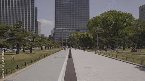 Kokyo Gaien National Garden with buildings in background - Wide moving forward shot on sunny day - Japan, Tokyo photo