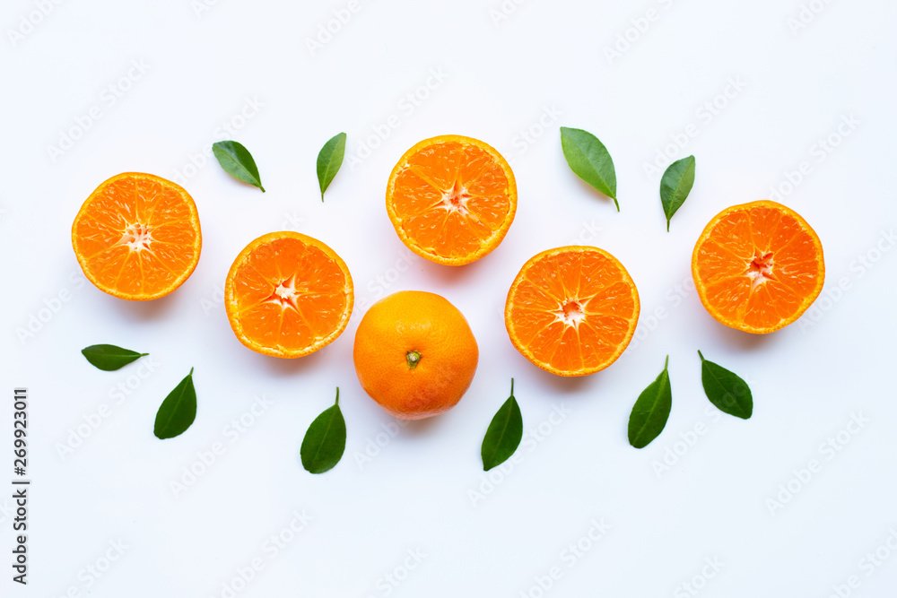 Fresh orange citrus fruit with green leaves on white. Fresh orange citrus fruit with green leaves on white.