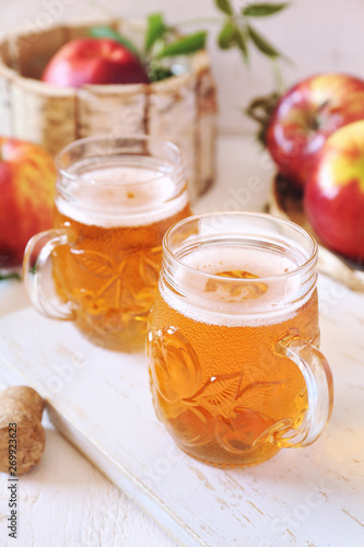 Two cups of Apple Cider and red apples