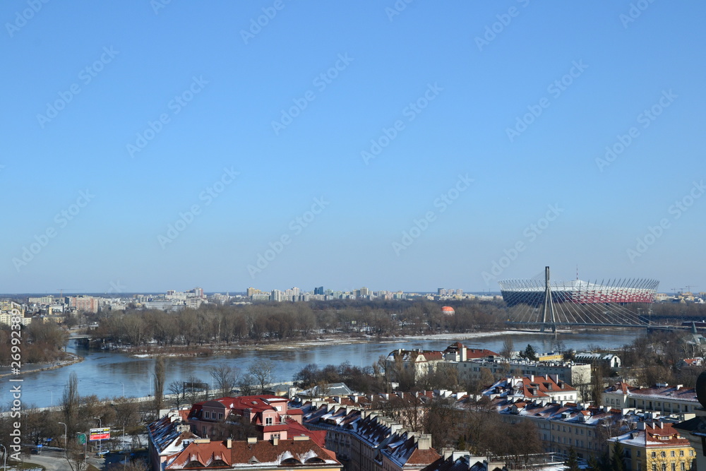Obraz premium Warsaw, Poland. Cityscape of Warsaw with Slasko-Dabrowski Bridge and Vistula river, aerial view from the bell tower of the St. Anne church. W-Z route