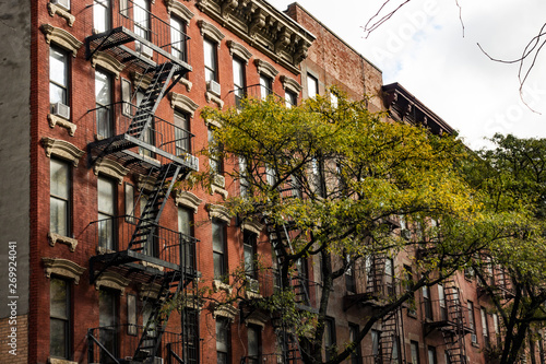 Close-up view of New York City style apartment buildings with emergency stairs along Mott Street in Chinatown neighborhood of Manhattan, New York, United States. photo