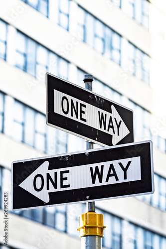 Close-up view of 'one way' road sign with blurred building in the background. Manhattan, New York City, United States of America. © Travel Wild