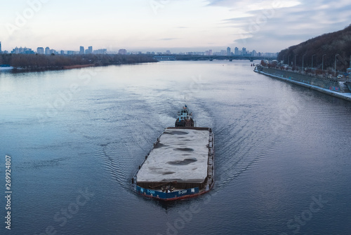 The barge floating in the Dnieper river. Kyiv city landscape in the background. 17.11.2018