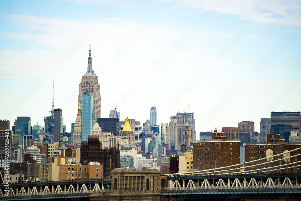 (Selective focus) Stunning view of the Manhattan Bridge and the beautiful skyline of New York seen from the Brooklyn bridge. Manhattan, New York City, USA.